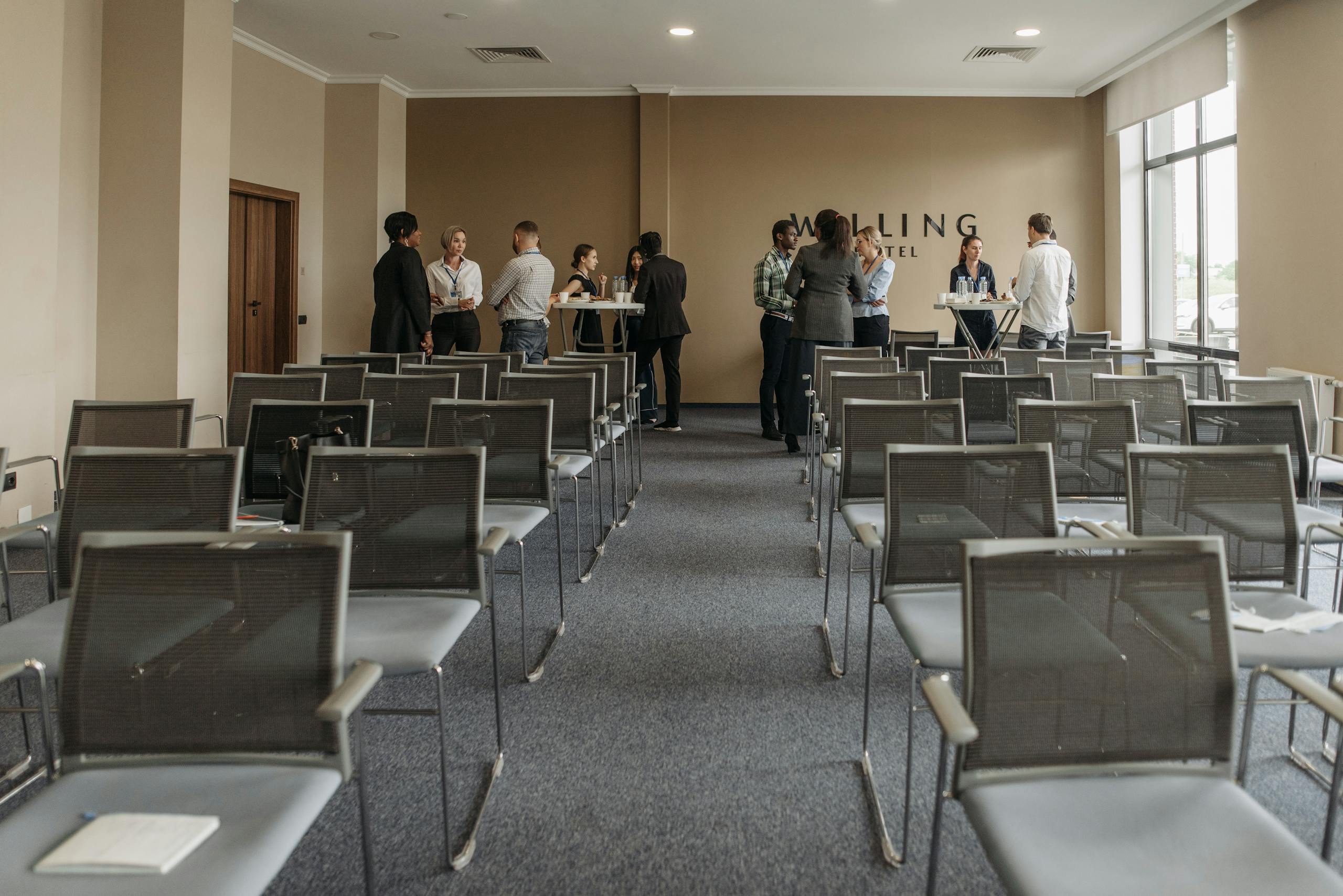 Business professionals networking in a conference room setting.